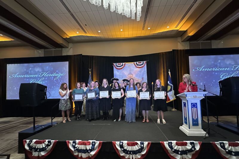 events page header image A group of teachers holding certificates on stage at the American Heritage gala teacher appreciation event